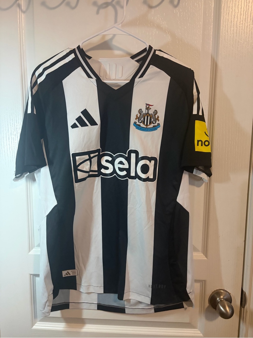 The front is a Newcastle United 2024/25 adidas jersey